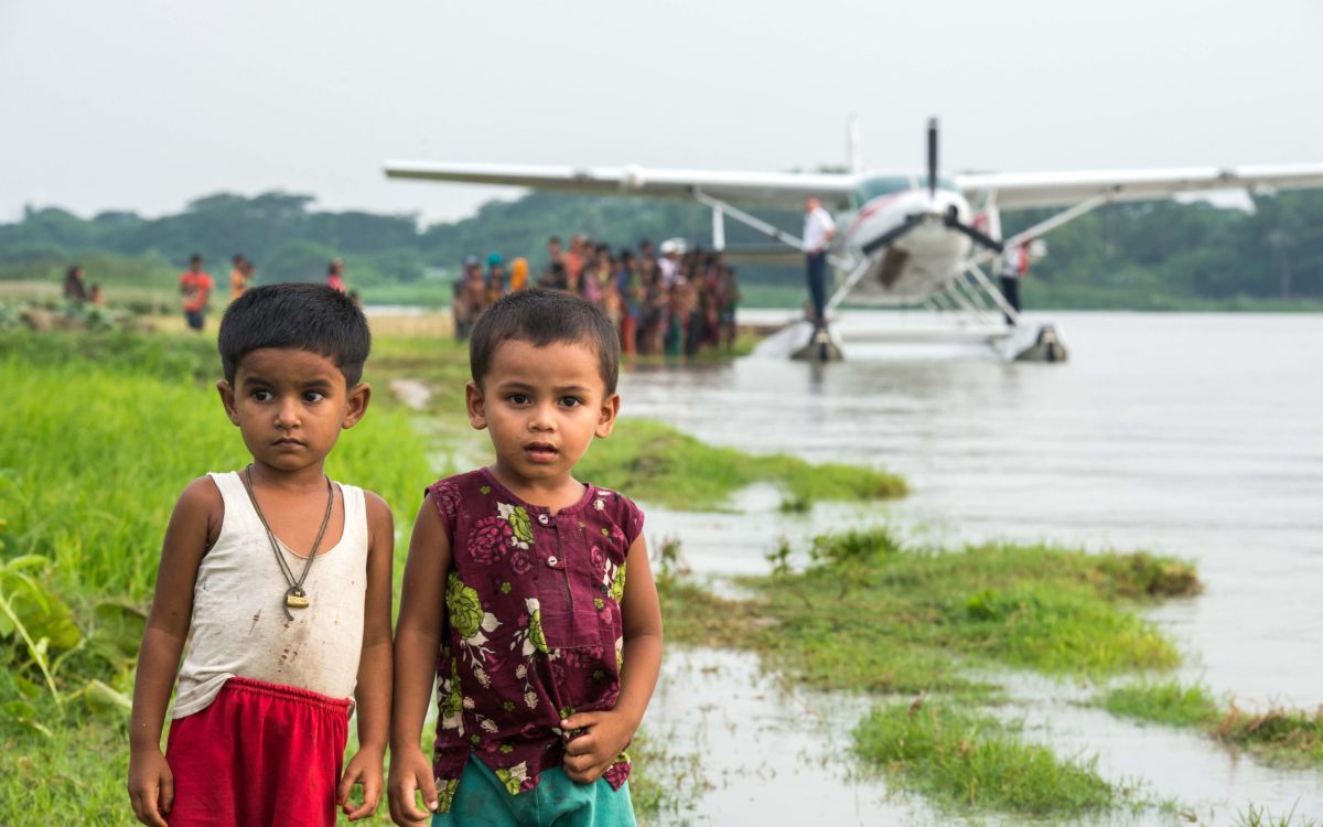 Crowds of children and adults gather to watch the float plane that landed in Bhola, Bangladesh.